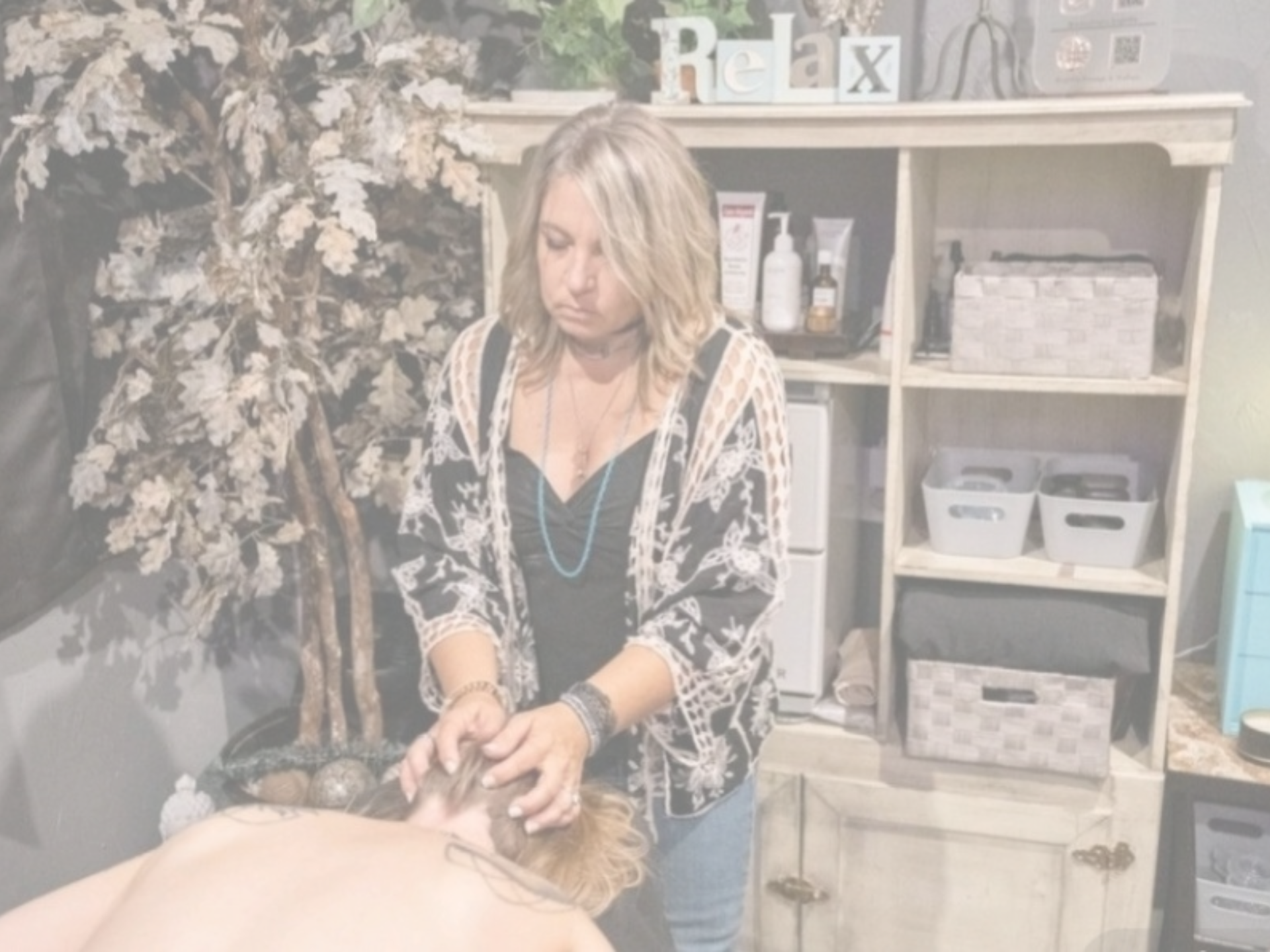 Massage therapist Jessa giving a client a relaxing head massage